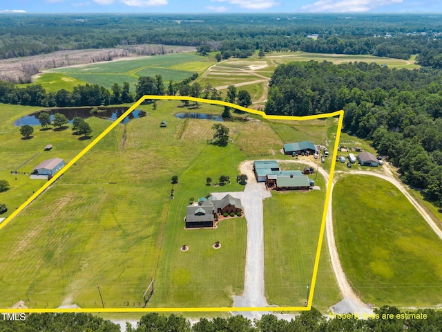 aerial view of sparsely populated area featuring property parcel outlined and a nearby body of water