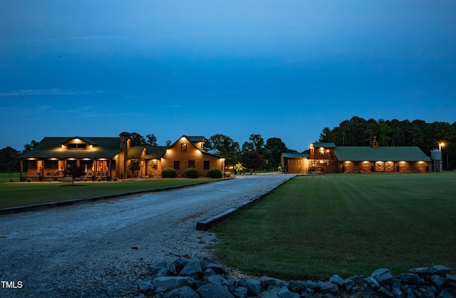 view of front facade with a front yard and curved driveway