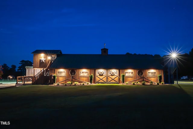 view of front of house with a chimney and a metal roof