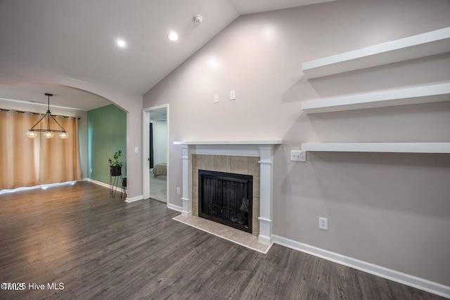 82 Mamie Rd, Benson, NC 27504 - unfurnished living room featuring a chandelier, a tile fireplace, wood finished floors, recessed lighting, and arched walkways