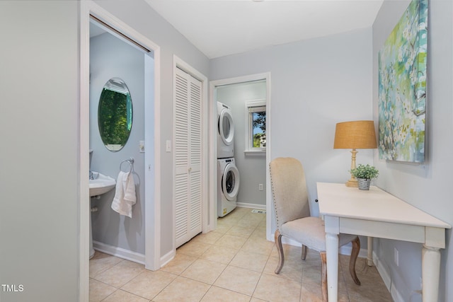 5900 Holly Dr, Raleigh, NC 27616 - laundry room featuring stacked washer / dryer and light tile patterned floors