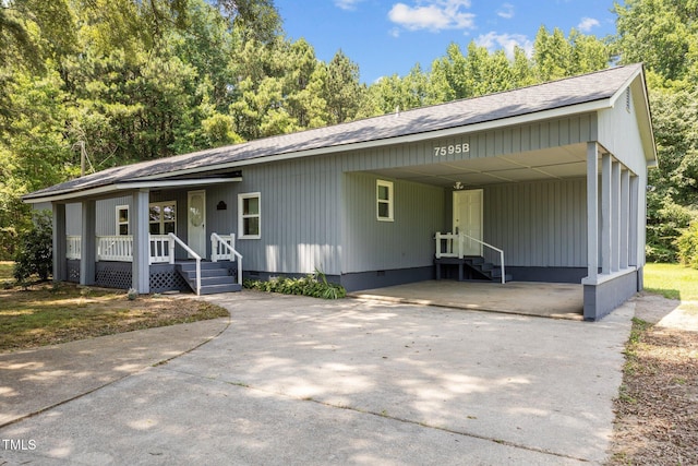7595 Clayton Blvd Unit B, Clayton, NC 27520 - view of front facade with concrete driveway, covered porch, a shingled roof, an attached carport, and entry steps