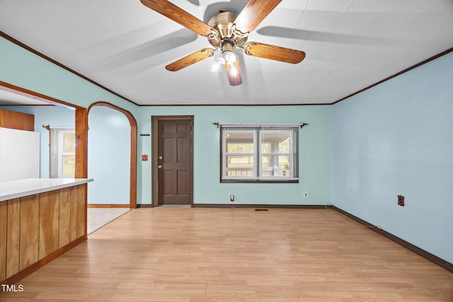 7595 Clayton Blvd Unit B, Clayton, NC 27520 - unfurnished living room with light wood-type flooring, healthy amount of natural light, a ceiling fan, crown molding, and arched walkways