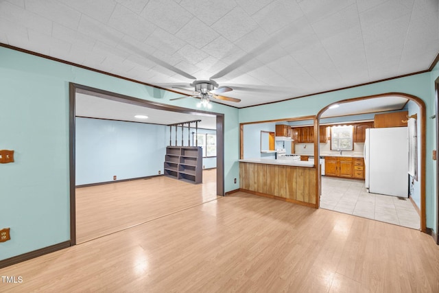 7595 Clayton Blvd Unit B, Clayton, NC 27520 - unfurnished living room with light wood-style flooring, a ceiling fan, healthy amount of natural light, arched walkways, and crown molding