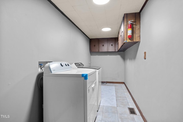 7595 Clayton Blvd Unit B, Clayton, NC 27520 - washroom with washer and clothes dryer, cabinet space, and light tile patterned floors