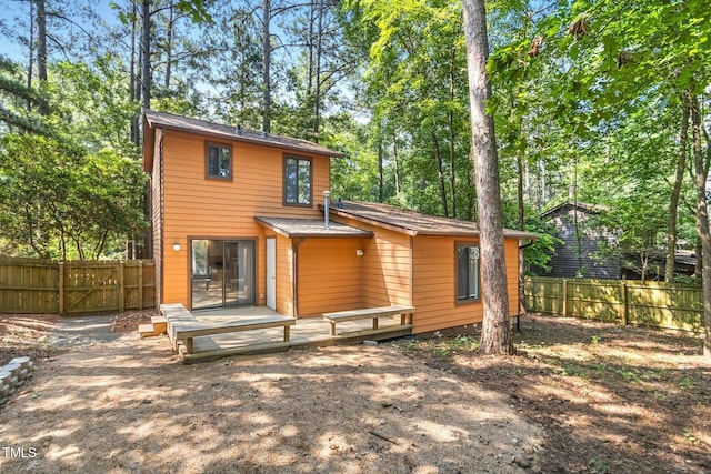 18 Frances St, Chapel Hill, NC 27517 - back of house with a fenced backyard, a deck, and view of scattered trees