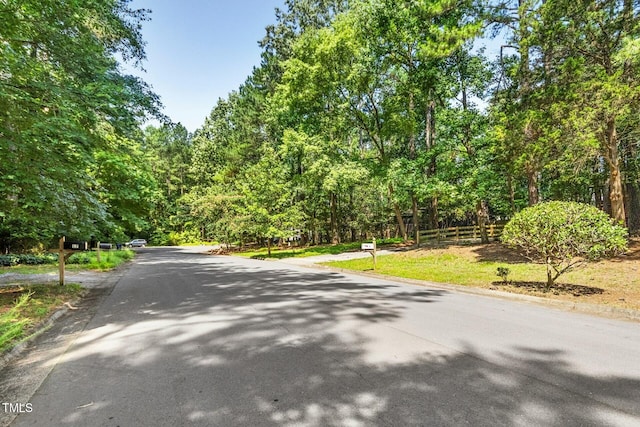 18 Frances St, Chapel Hill, NC 27517 - view of asphalt road with a wooded view