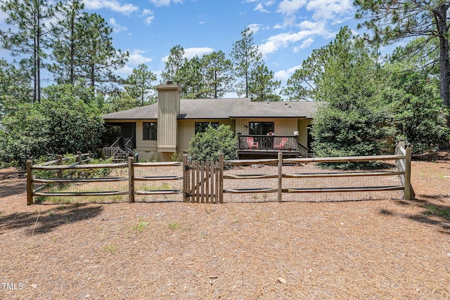 6 Driving Range Rd, Pinehurst, NC 28374 - view of front of property featuring a gate, roof with shingles, and a chimney