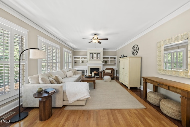 204 Edgepine Dr, Holly Springs, NC 27540 - living room with a ceiling fan, plenty of natural light, ornamental molding, wood finished floors, and a large fireplace