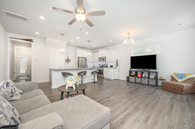 321 Conrad Ln, Wake Forest, NC 27587 - living area featuring light wood finished floors, a chandelier, recessed lighting, and ceiling fan