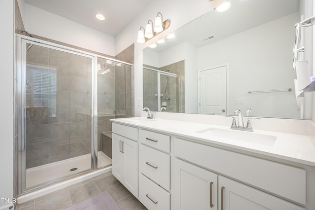 321 Conrad Ln, Wake Forest, NC 27587 - bathroom with double vanity, tile patterned flooring, a shower stall, and recessed lighting