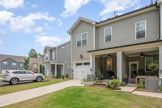 321 Conrad Ln, Wake Forest, NC 27587 - rear view of house featuring concrete driveway, an attached garage, a lawn, ceiling fan, and a residential view
