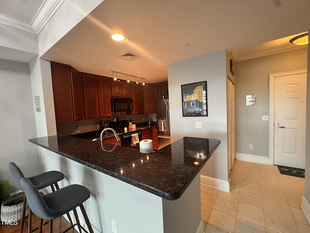 510 Glenwood Ave Unit 606, Raleigh, NC 27603 - kitchen featuring black appliances, a peninsula, crown molding, a kitchen bar, and track lighting