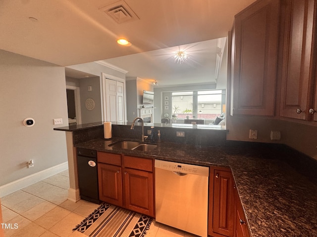 510 Glenwood Ave Unit 606, Raleigh, NC 27603 - kitchen with dishwasher, brown cabinets, a peninsula, dark stone countertops, and crown molding