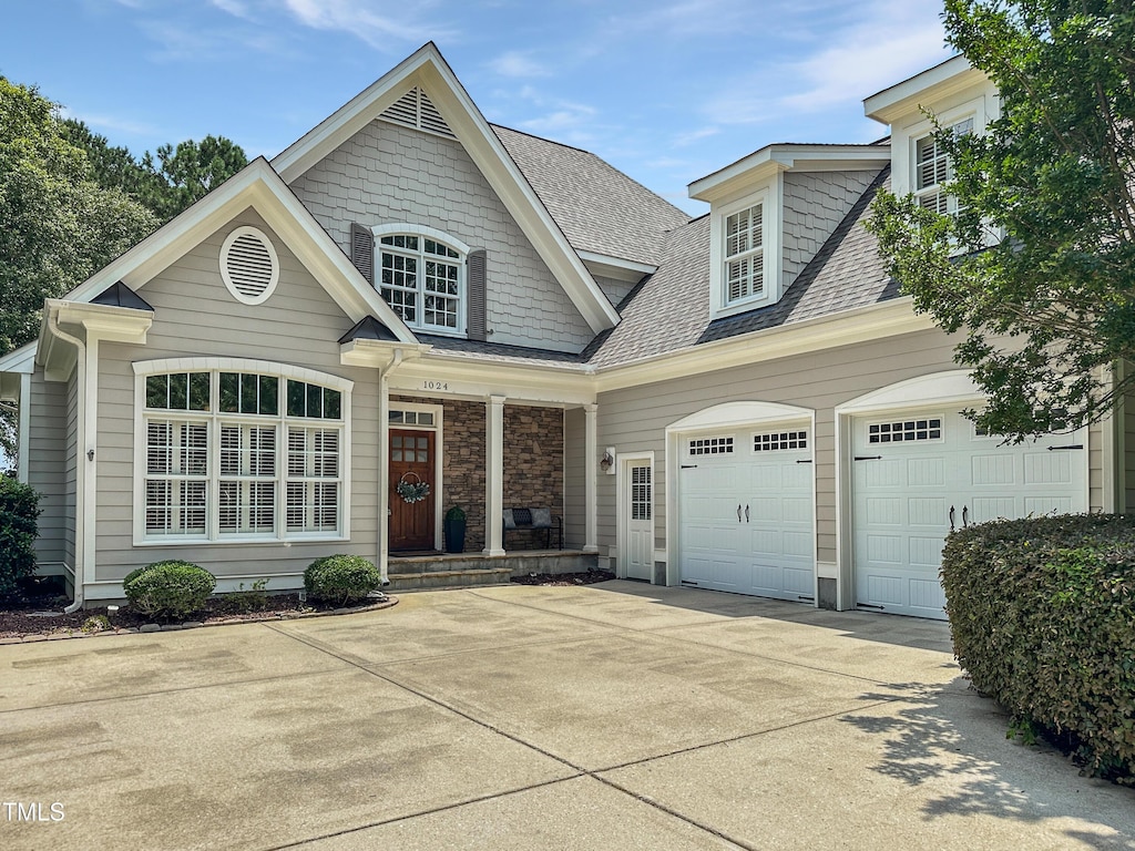 1024 Prairie Smoke St, Wake Forest, NC 27587 - view of front of home featuring driveway, a shingled roof, and a porch