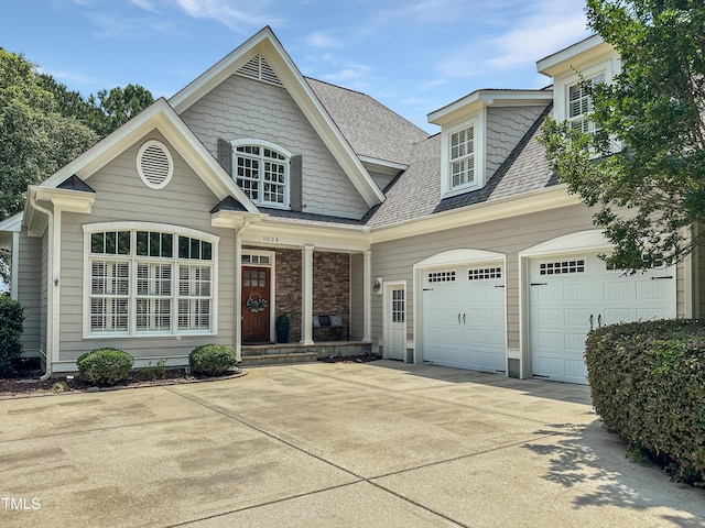 1024 Prairie Smoke St, Wake Forest, NC 27587 - view of front of home featuring driveway, a shingled roof, and a porch