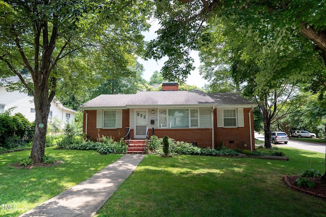 2100 Breeze Rd, Raleigh, NC 27608 - view of front of house featuring brick siding, a front lawn, and a chimney