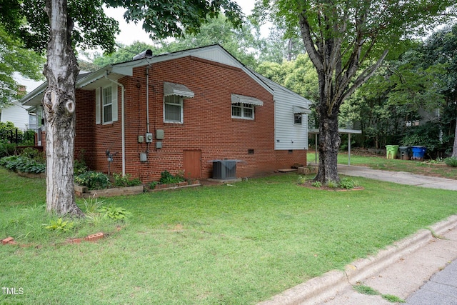 2100 Breeze Rd, Raleigh, NC 27608 - view of side of property featuring a yard, brick siding, crawl space, and driveway