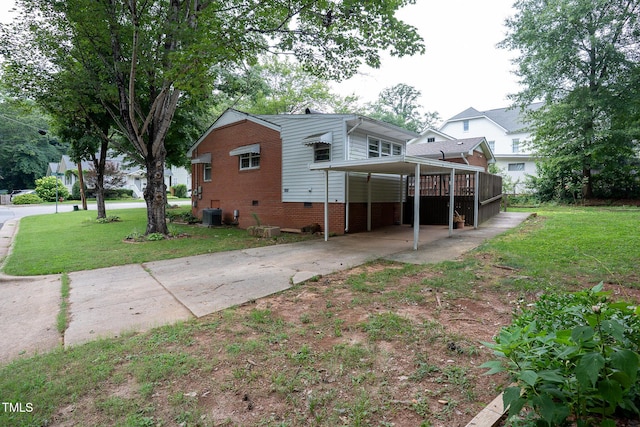 2100 Breeze Rd, Raleigh, NC 27608 - back of property with driveway, a carport, a lawn, and brick siding