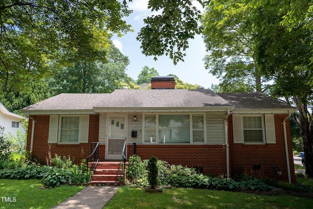2100 Breeze Rd, Raleigh, NC 27608 - view of front of house with brick siding, a chimney, and a shingled roof