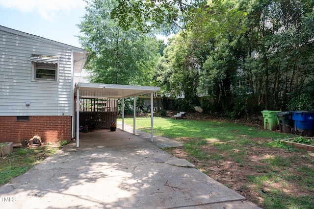 2100 Breeze Rd, Raleigh, NC 27608 - view of green lawn with driveway and an attached carport