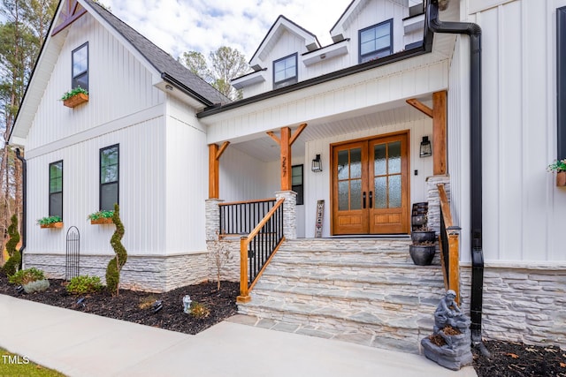 257 Rawhide Dr, Louisburg, NC 27549 - entrance to property featuring a porch, french doors, stone siding, and board and batten siding