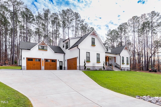257 Rawhide Dr, Louisburg, NC 27549 - modern farmhouse style home featuring driveway, a porch, a front yard, and board and batten siding
