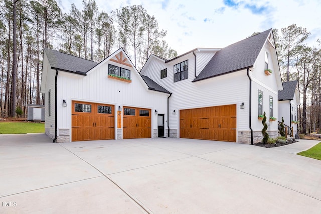 257 Rawhide Dr, Louisburg, NC 27549 - view of front of house with stone siding, roof with shingles, driveway, and board and batten siding