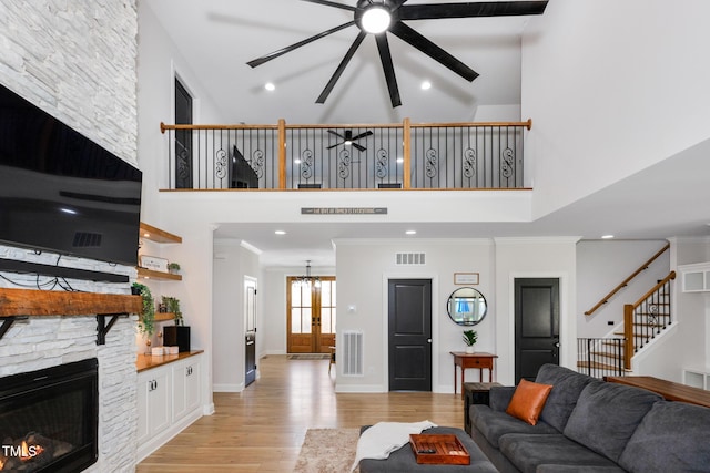 257 Rawhide Dr, Louisburg, NC 27549 - living area with a high ceiling, ceiling fan, light wood finished floors, stairway, and recessed lighting