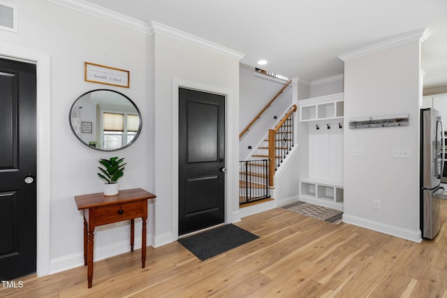 257 Rawhide Dr, Louisburg, NC 27549 - entrance foyer with light wood-style floors, ornamental molding, stairway, and recessed lighting