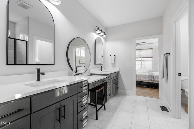 257 Rawhide Dr, Louisburg, NC 27549 - ensuite bathroom featuring marble finish flooring, double vanity, and an enclosed shower