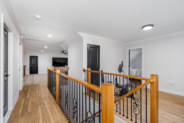 257 Rawhide Dr, Louisburg, NC 27549 - hallway with an upstairs landing, light wood-type flooring, crown molding, and recessed lighting