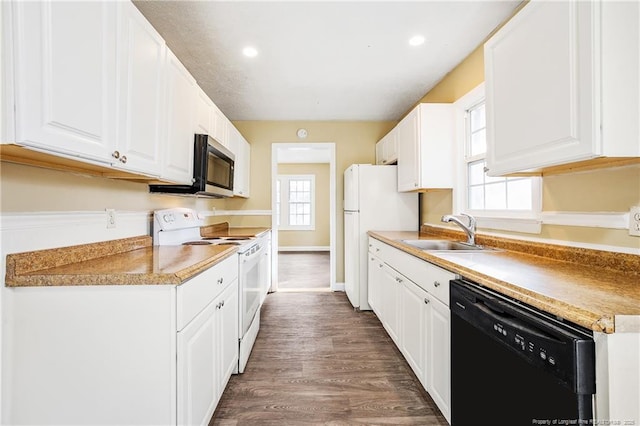 334 Richmond Dr, Fayetteville, NC 28304 - kitchen with white appliances, white cabinetry, wood finished floors, light countertops, and recessed lighting