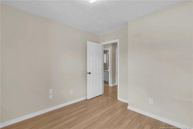6324 Foxlake Dr, Fayetteville, NC 28314 - spare room featuring light wood-style flooring and a textured ceiling