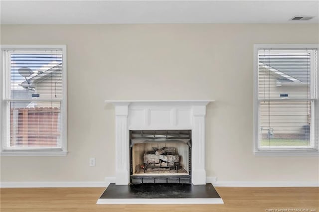 6324 Foxlake Dr, Fayetteville, NC 28314 - detailed view of wood finished floors and a fireplace with raised hearth