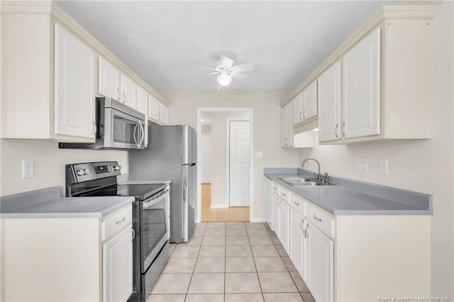 6324 Foxlake Dr, Fayetteville, NC 28314 - kitchen with stainless steel appliances, ceiling fan, white cabinets, and light tile patterned floors