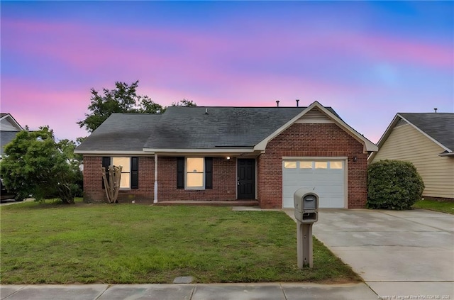 6324 Foxlake Dr, Fayetteville, NC 28314 - ranch-style house featuring an attached garage, concrete driveway, a front yard, and brick siding