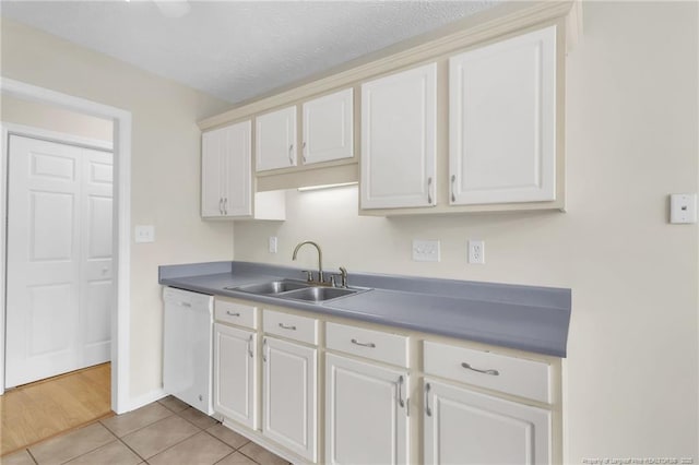 6324 Foxlake Dr, Fayetteville, NC 28314 - kitchen featuring dishwasher, light tile patterned flooring, and white cabinetry