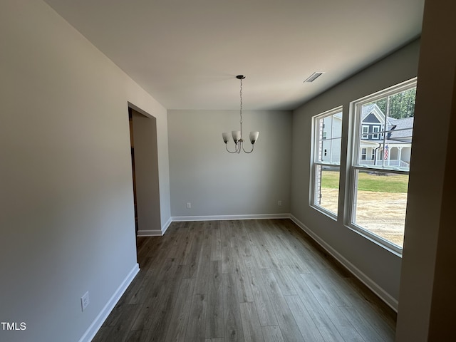 57 Blanton Ct, Lillington, NC 27546 - unfurnished dining area featuring a chandelier and dark wood-type flooring