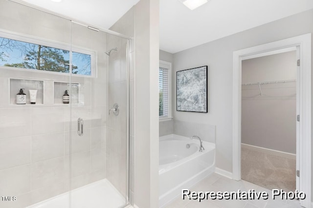 59 Curling Creek Dr Unit I285, Clayton, NC 27527 - full bathroom featuring a garden tub, a spacious closet, a shower stall, and tile patterned floors