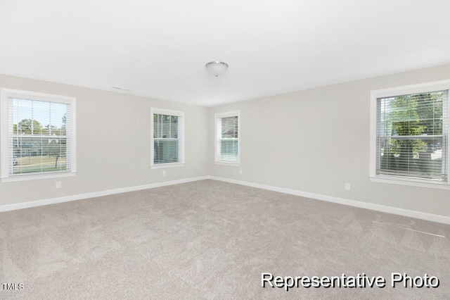 59 Curling Creek Dr Unit I285, Clayton, NC 27527 - spare room with carpet flooring and plenty of natural light