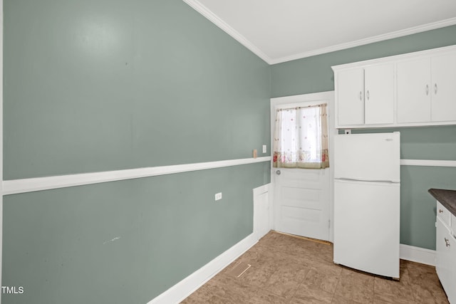 907 Morehead Ave, Durham, NC 27707 - kitchen with freestanding refrigerator, ornamental molding, and white cabinetry