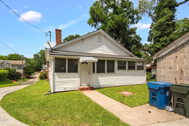 907 Morehead Ave, Durham, NC 27707 - view of front of home with a chimney, a front lawn, and roof with shingles