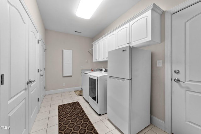 1221 Sagamore Dr, Louisburg, NC 27549 - washroom with cabinet space, separate washer and dryer, and light tile patterned floors
