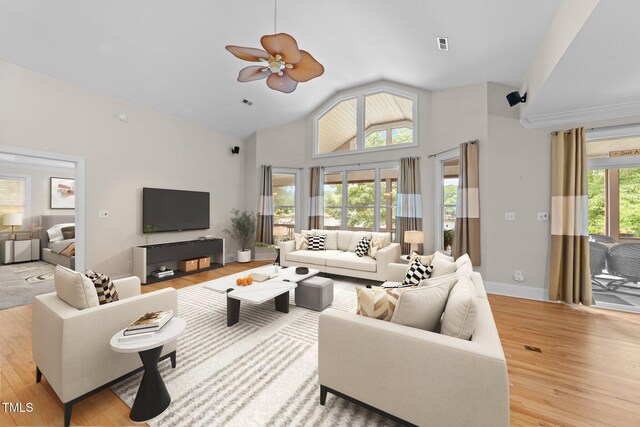 1221 Sagamore Dr, Louisburg, NC 27549 - living area with wood finished floors, ceiling fan, and high vaulted ceiling