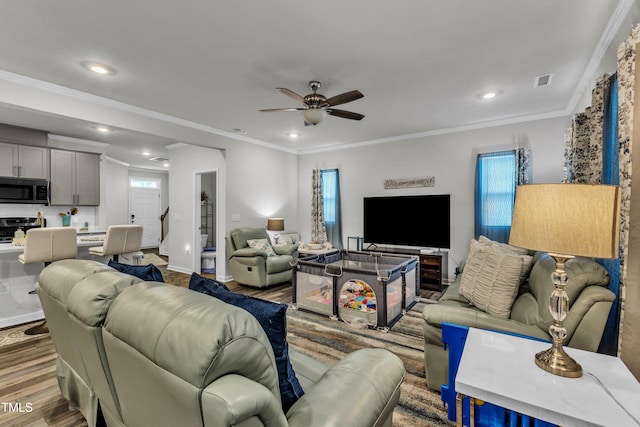 220 Garden Vine Trl, Raleigh, NC 27610 - living area with ceiling fan, wood finished floors, plenty of natural light, recessed lighting, and ornamental molding