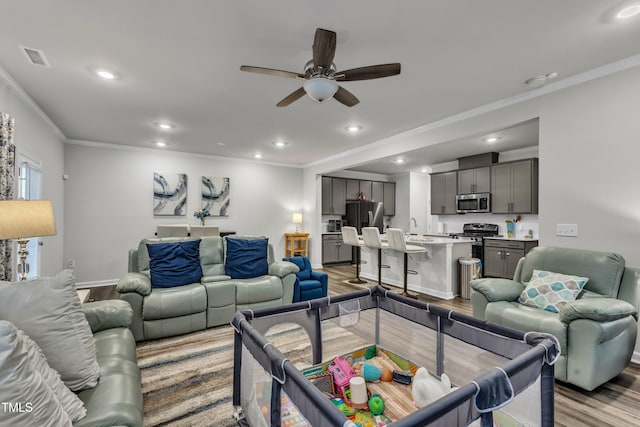 220 Garden Vine Trl, Raleigh, NC 27610 - living area with wood finished floors, ceiling fan, ornamental molding, and recessed lighting