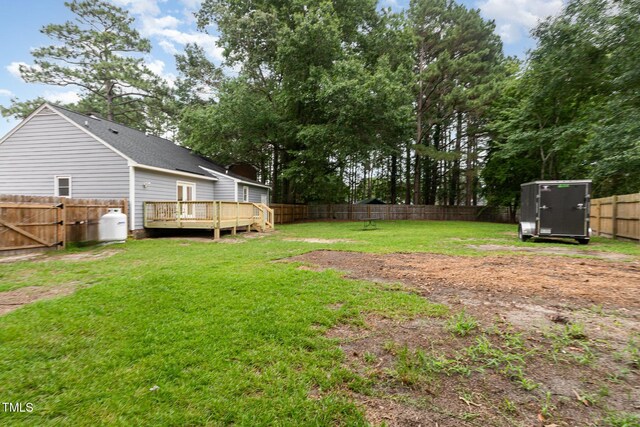 204 Valley Ct, Selma, NC 27576 - fenced backyard with a deck and a storage unit