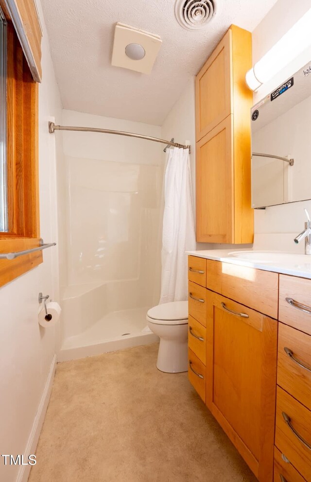 64 Robin Rd, Semora, NC 27343 - full bathroom with curtained shower, vanity, and a textured ceiling