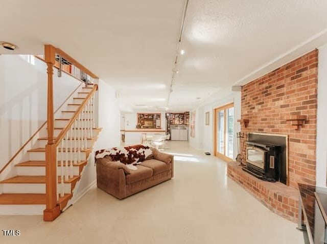 64 Robin Rd, Semora, NC 27343 - living room with track lighting, stairway, and concrete flooring